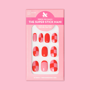 A close-up view of a package of press-on nails with a stylish pink and red checkerboard pattern, labeled