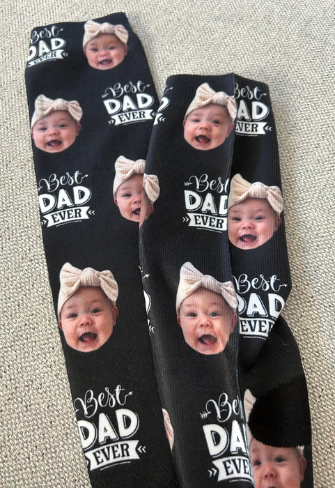 Socks featuring repeated images of a baby's face along with the text 