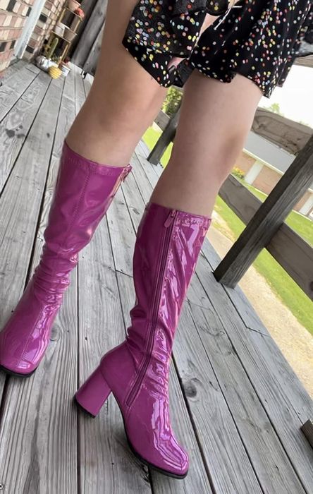 A reviewer showcasing the purple version of the boots.