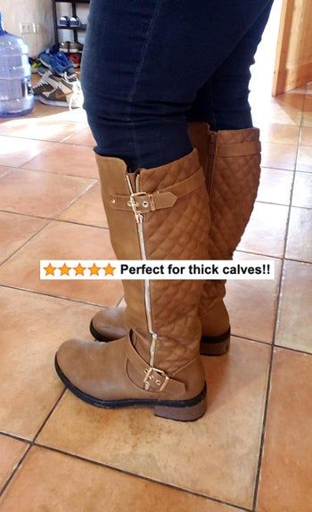 A reviewer showcasing the brown version of the boots.