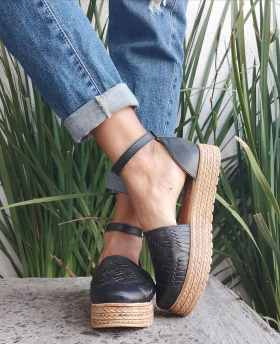 A model wearing the stylish black huarache sandals.