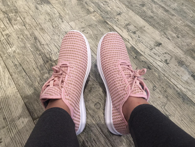 reviewer sporting the pink knitted lace-up sneakers