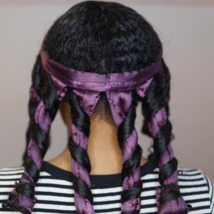 A reviewer with 3B/3C textured hair styled with the octocurl, wrapped around their head