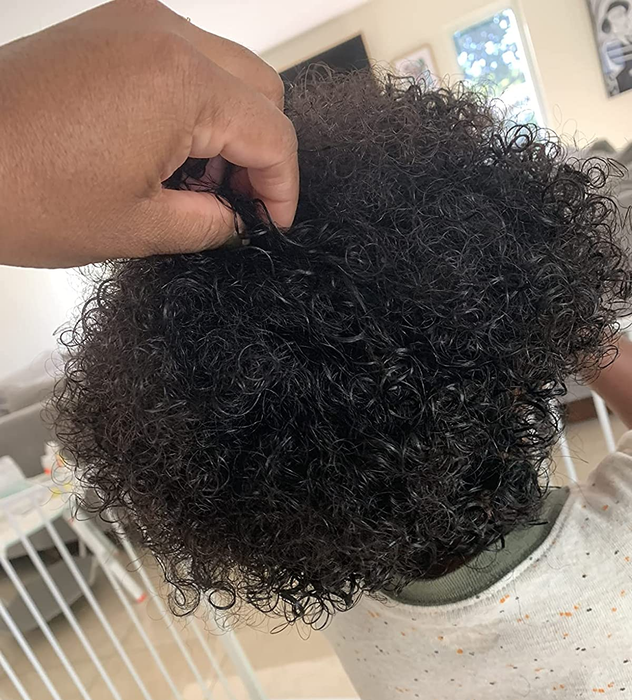 A picture of the reviewer's child showcasing their healthy, coiled hair texture.