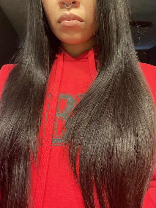 Image of a reviewer showcasing long, healthy, and shiny hair.