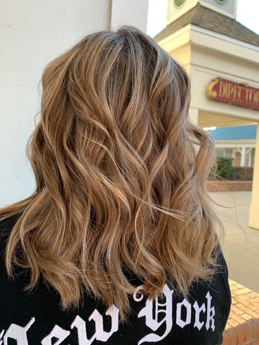 A reviewer showcases their frizz-free waves