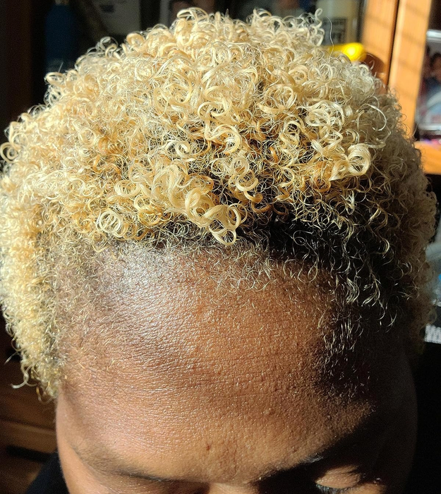 Close-up shot of a reviewer with shiny, short blonde coils.