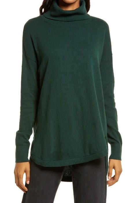 A model dressed in a green top paired with black pants.