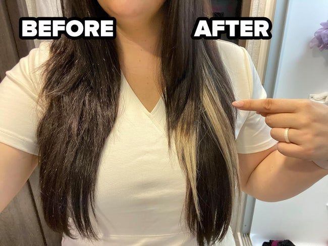 A reviewer showcasing the oil on one side of her head, where the hair appears smooth and shiny.
