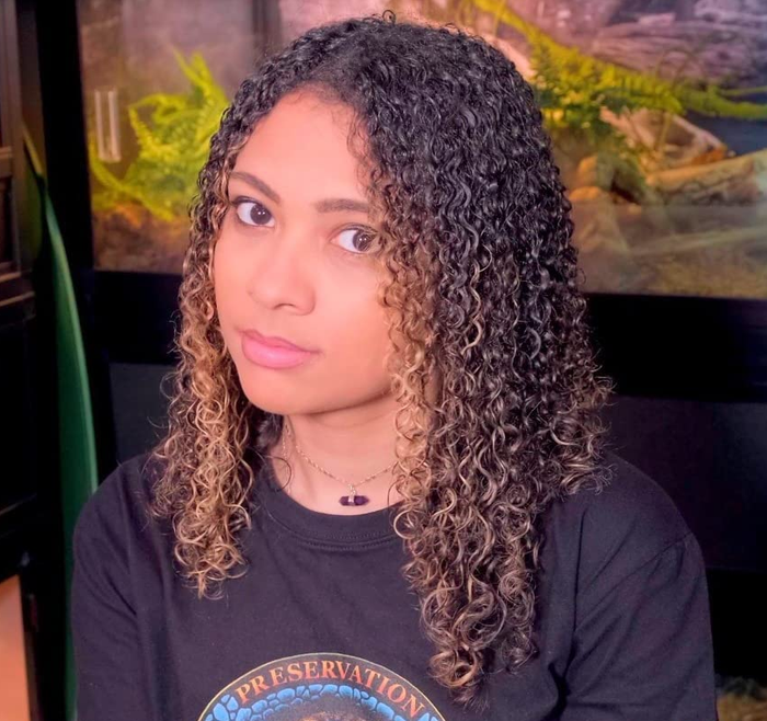 A reviewer displaying shiny, tight ribbon-like curls.