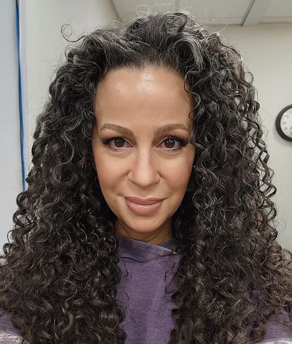 Image of a reviewer with shiny, bouncy curls.
