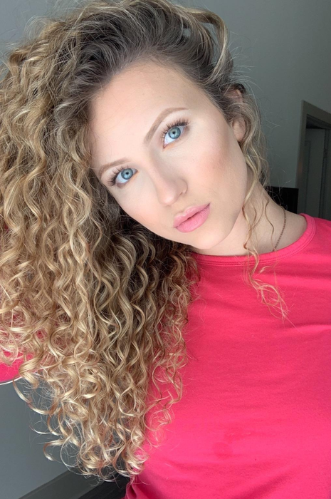Another reviewer displaying their long, curly hair, smooth and frizz-free.