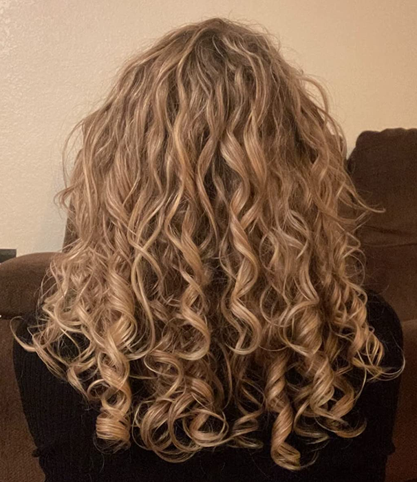 An image featuring a reviewer with blonde, ribbon-like curls.