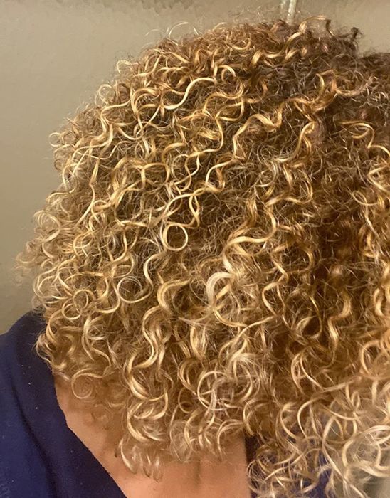 The reviewer’s hair after applying the Ouidad gel, showing defined curls and no frizz.