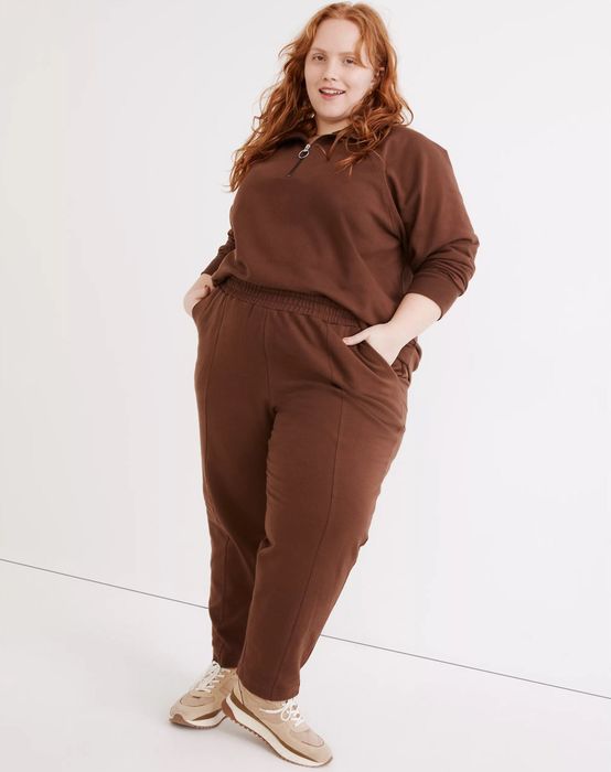 The model is wearing brown ribbed sweatpants.