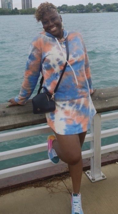 Reviewer wearing the blue and orange tie-dye hoodie dress.