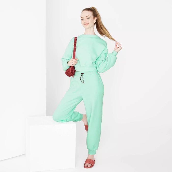 A model showcasing the light green joggers