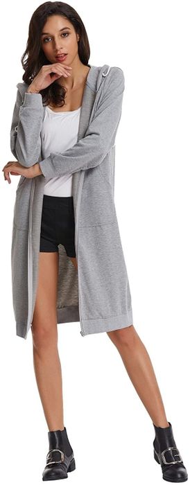 The model is wearing a long gray sweatshirt with the hood down.