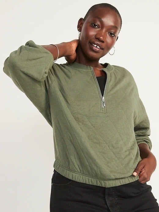 The model is dressed in an olive green sweatshirt.
