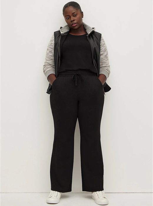 The front view of the model wearing black flared pants.