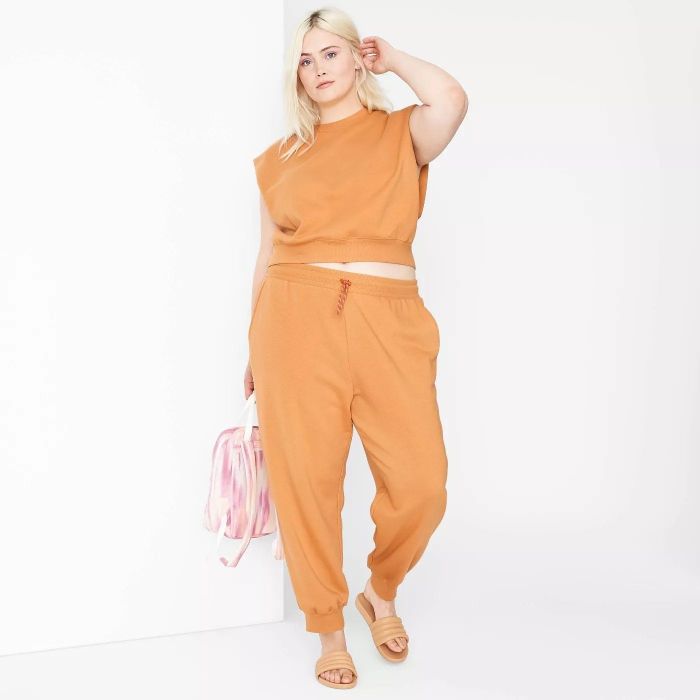 A model showcasing the orange joggers
