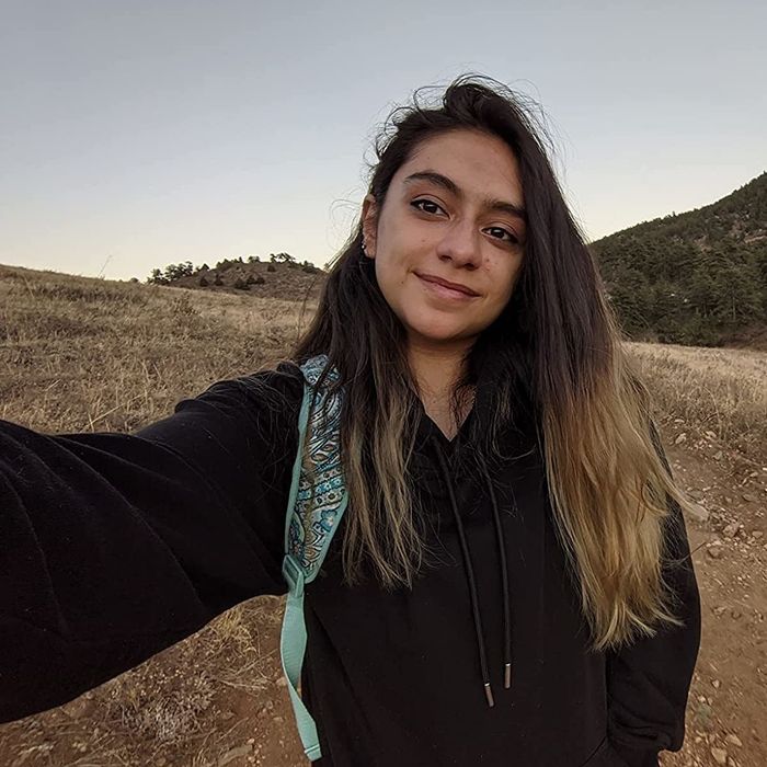 A reviewer wearing a sleek black hoodie.