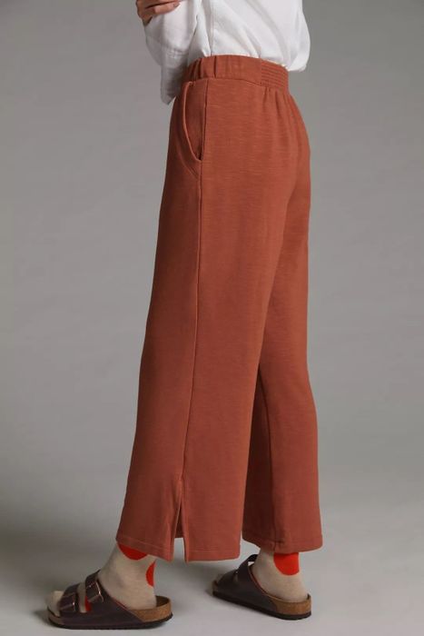 Side view of the model in the red lounge pants.