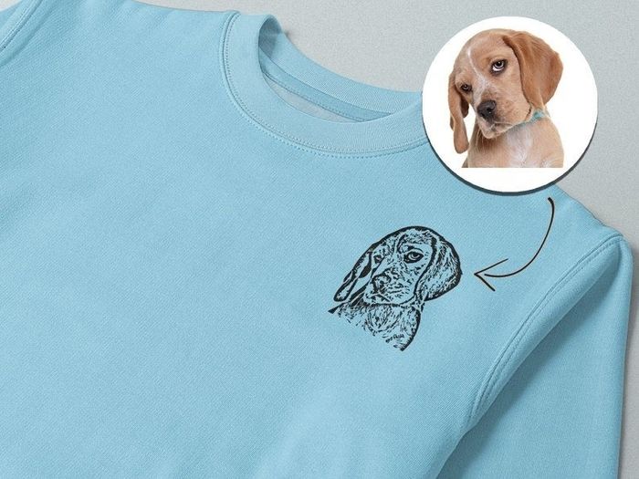A light blue sweatshirt featuring an image of a dog, alongside a photo of the dog that inspired the design.