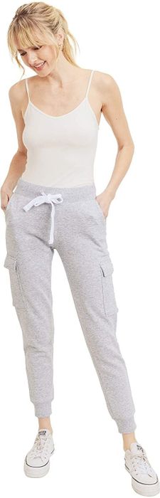 The model is wearing a pair of light gray joggers.