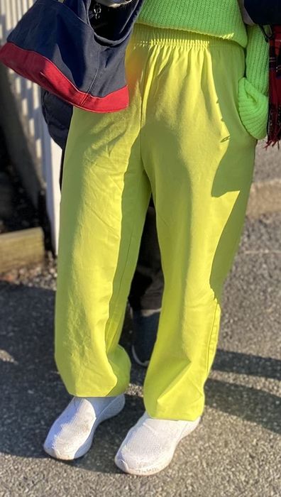 The reviewer is wearing light green sweatpants.