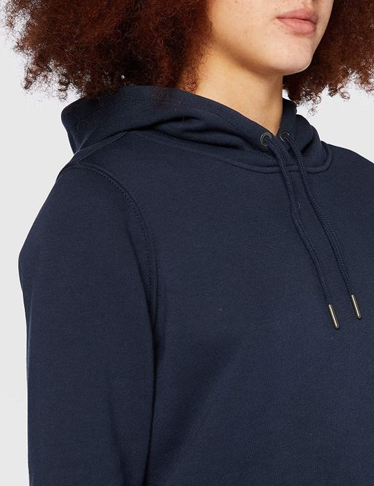 A close-up of a model dressed in a navy hoodie.