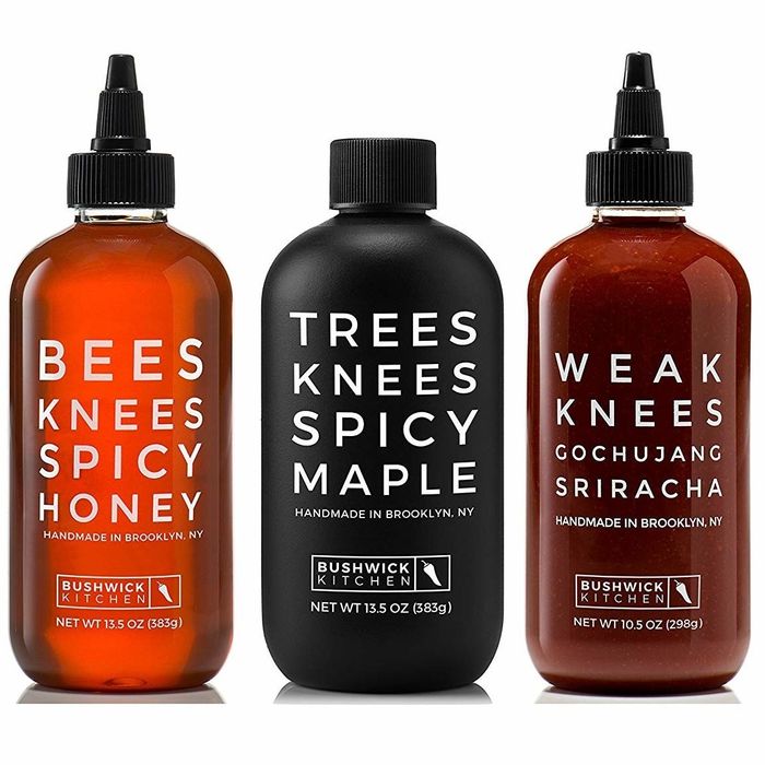 The trio of spicy sauces, including honey, maple syrup, and gochujang sriracha, perfect for adding a bold kick to any meal.