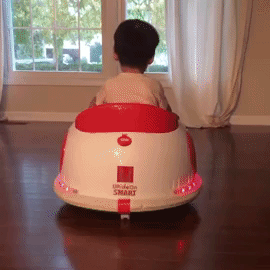 A GIF of the reviewer’s baby riding a bumper car from the back, with flashing lights