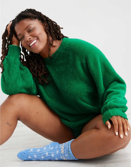 A model showcasing the bright leaf green sweater.