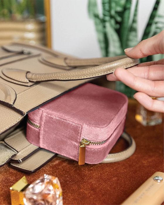 The soft pink jewelry case with a sleek, closed design, perfect for keeping precious accessories safe and stylish.