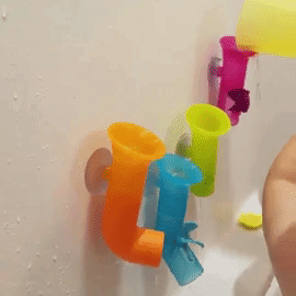 A gif shared by the reviewer, showing their child playing with the bath pipes and pouring water during bath time.