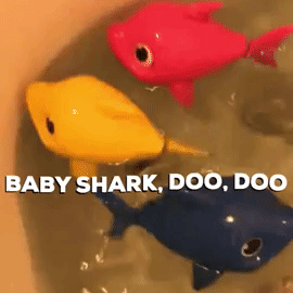 A gif shared by a reviewer showing the pink, yellow, and blue baby shark toys swimming around in the bathtub