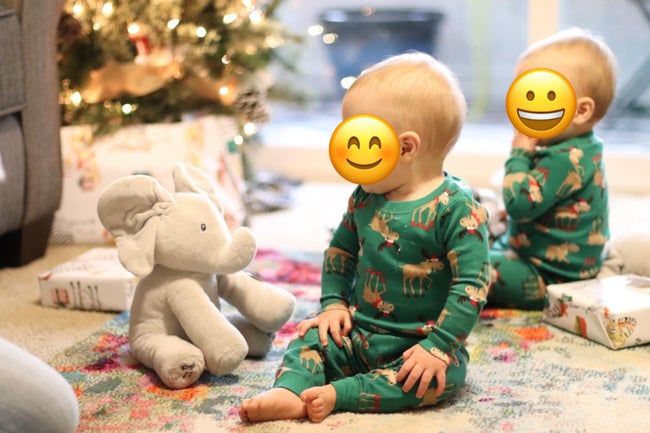 A child sitting beside the cuddly stuffed elephant.