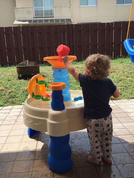 The child of the reviewer enjoying the water table.