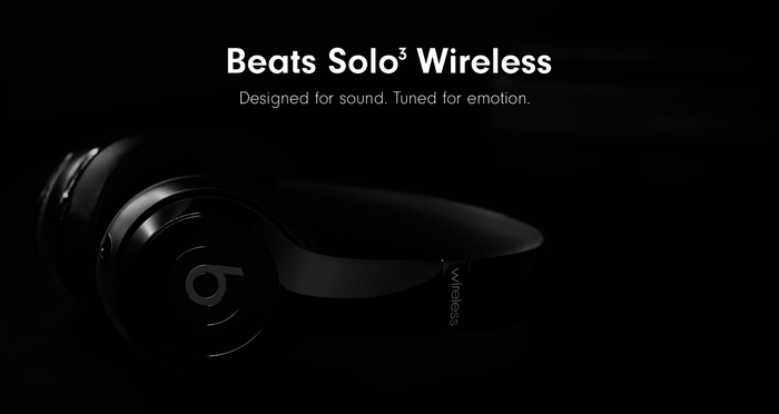 The headphones in sleek black, engraved with the phrase 'designed for sound. tuned for emotion.'