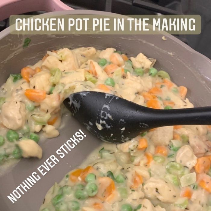 Me preparing the filling for a chicken pot pie with the text: 'Nothing ever sticks!' showcasing the pan's nonstick surface.