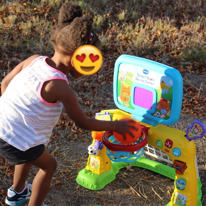 A child making a dunk in the sports center's basketball hoop