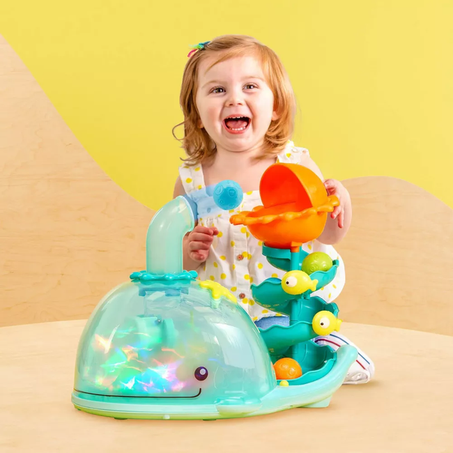 A child joyfully playing with the toy