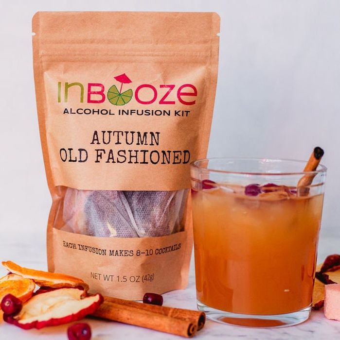 The infusion bag with the pouch nestled inside, placed beside a finished cocktail.