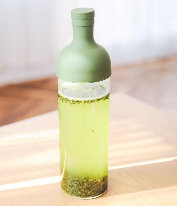 The tea maker designed in the shape of a wine bottle.