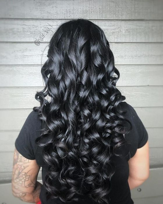 A reviewer showcasing their beautifully curled hair