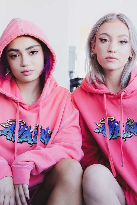 Avani and her friend proudly sport pink hoodies emblazoned with her name.