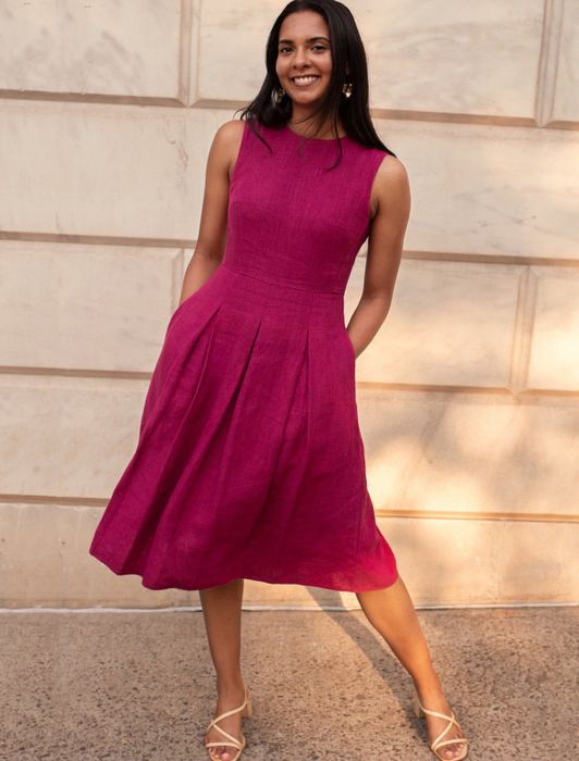 A model is wearing the bonbon dress in a soft pink shade.