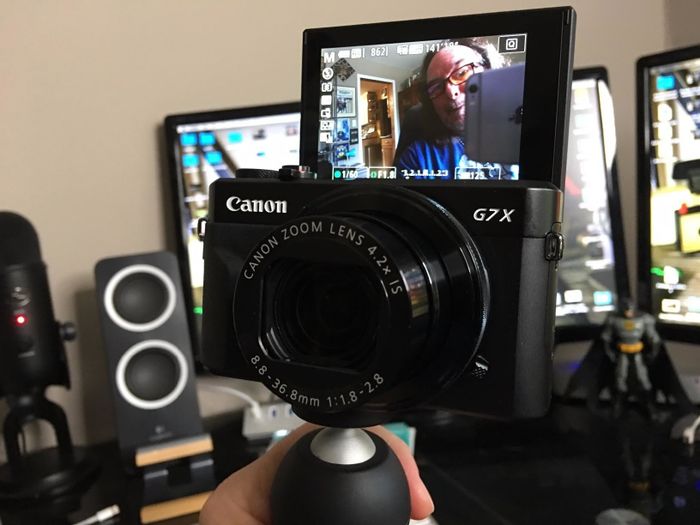 A person positions the camera to display the flip screen