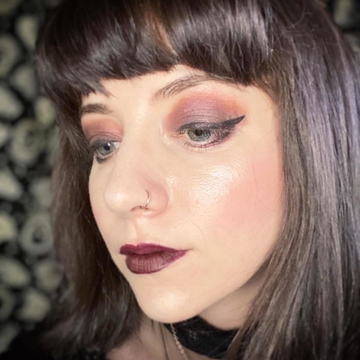 A woman showcases the effects of the ring light with a selfie